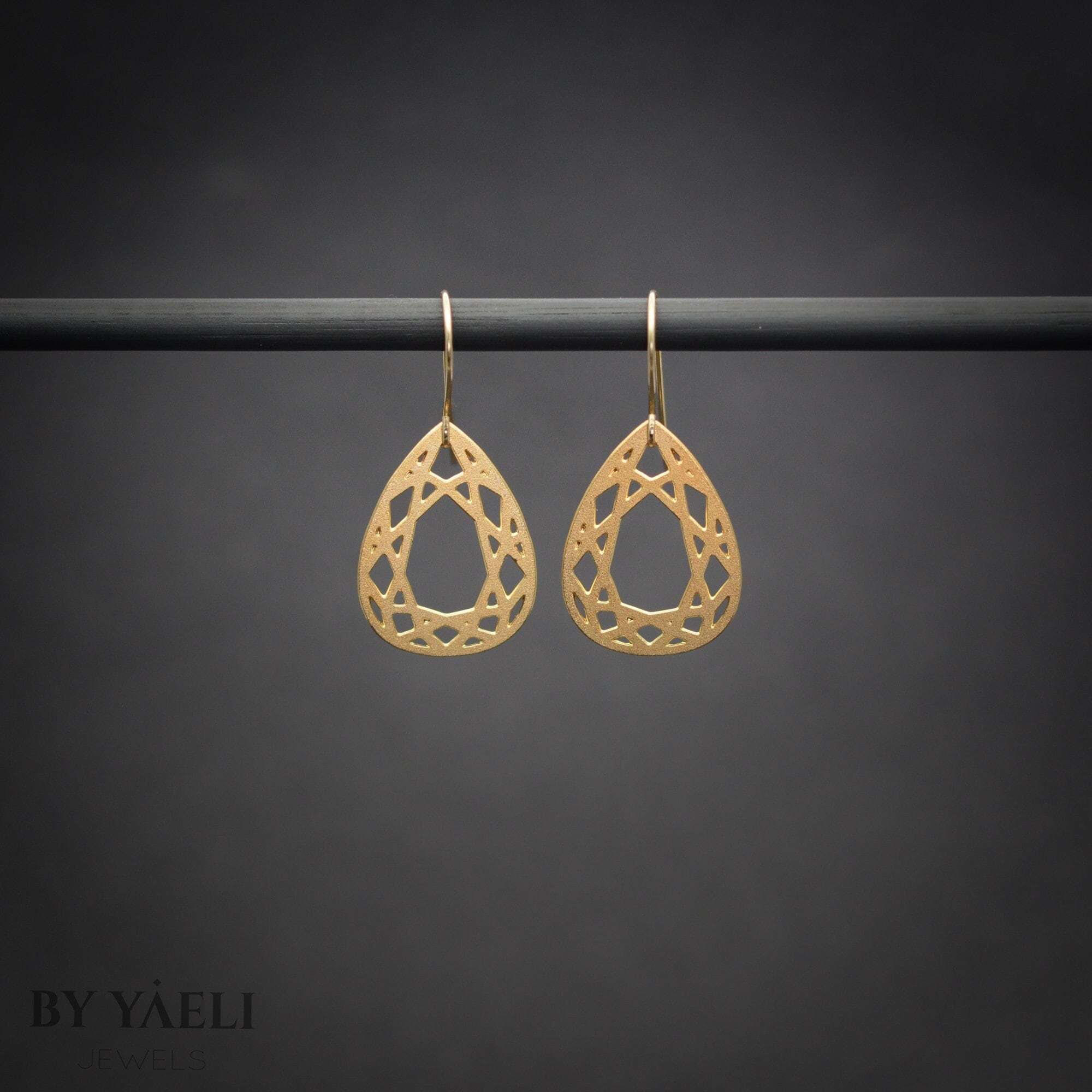 Gold tear drop diamond shape dangle earrings.