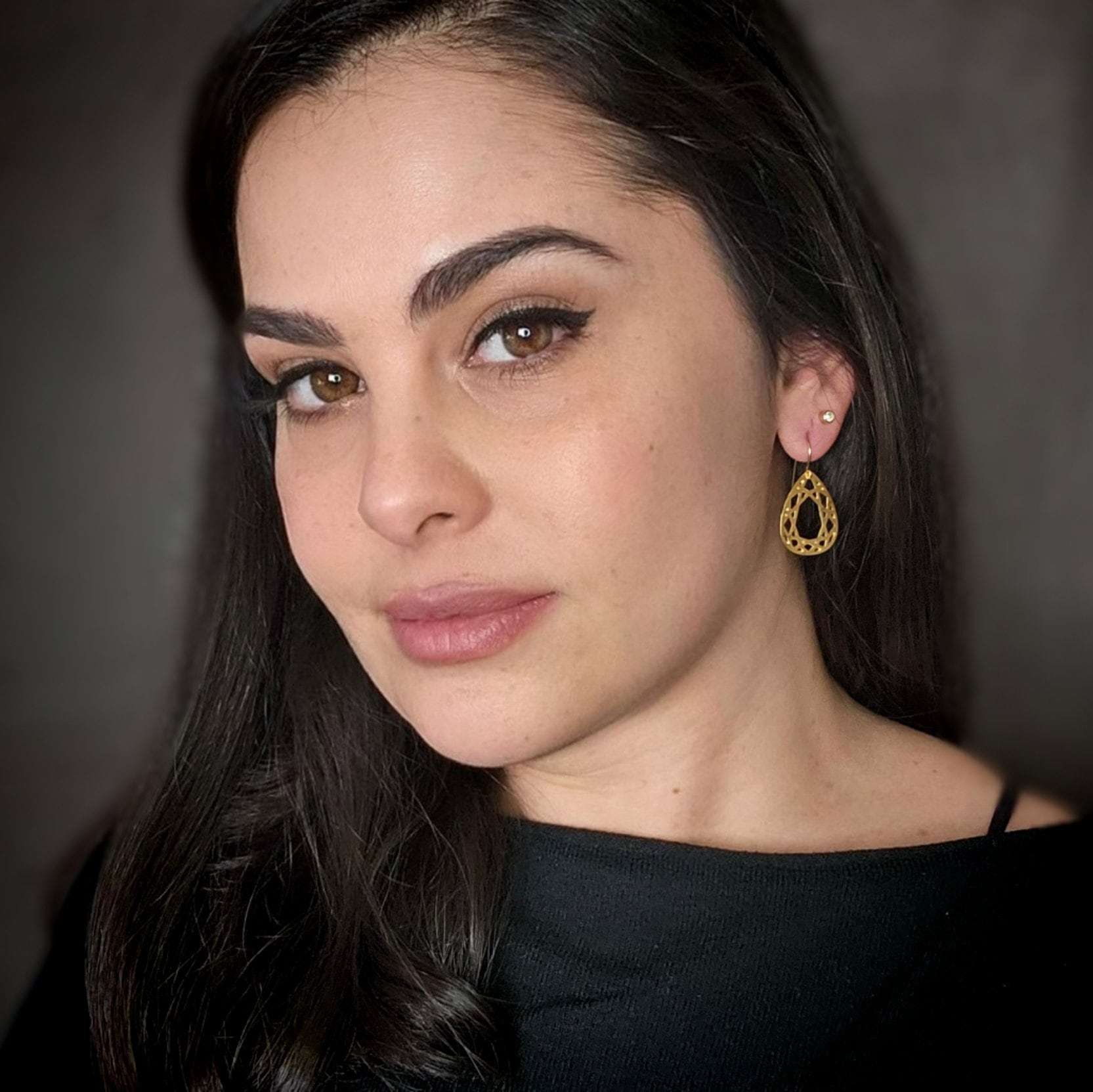 Gold tear drop diamond shape dangle earrings.