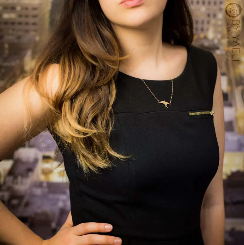 Bird necklace gold swallow bird necklace bird jewelry bird charm bird pendant swallow pendant 3 a woman in a black dress with a delicate gold bird necklace